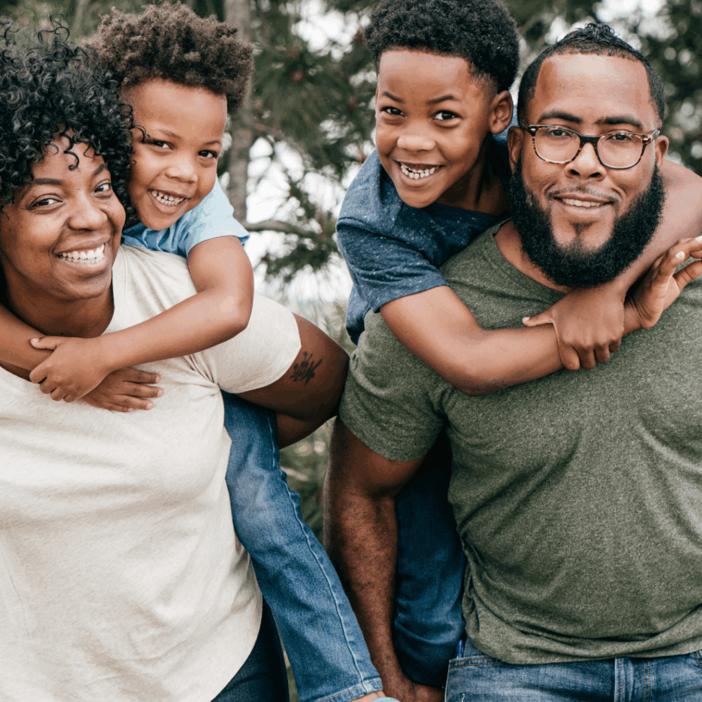 Smiling family, two children two adults.