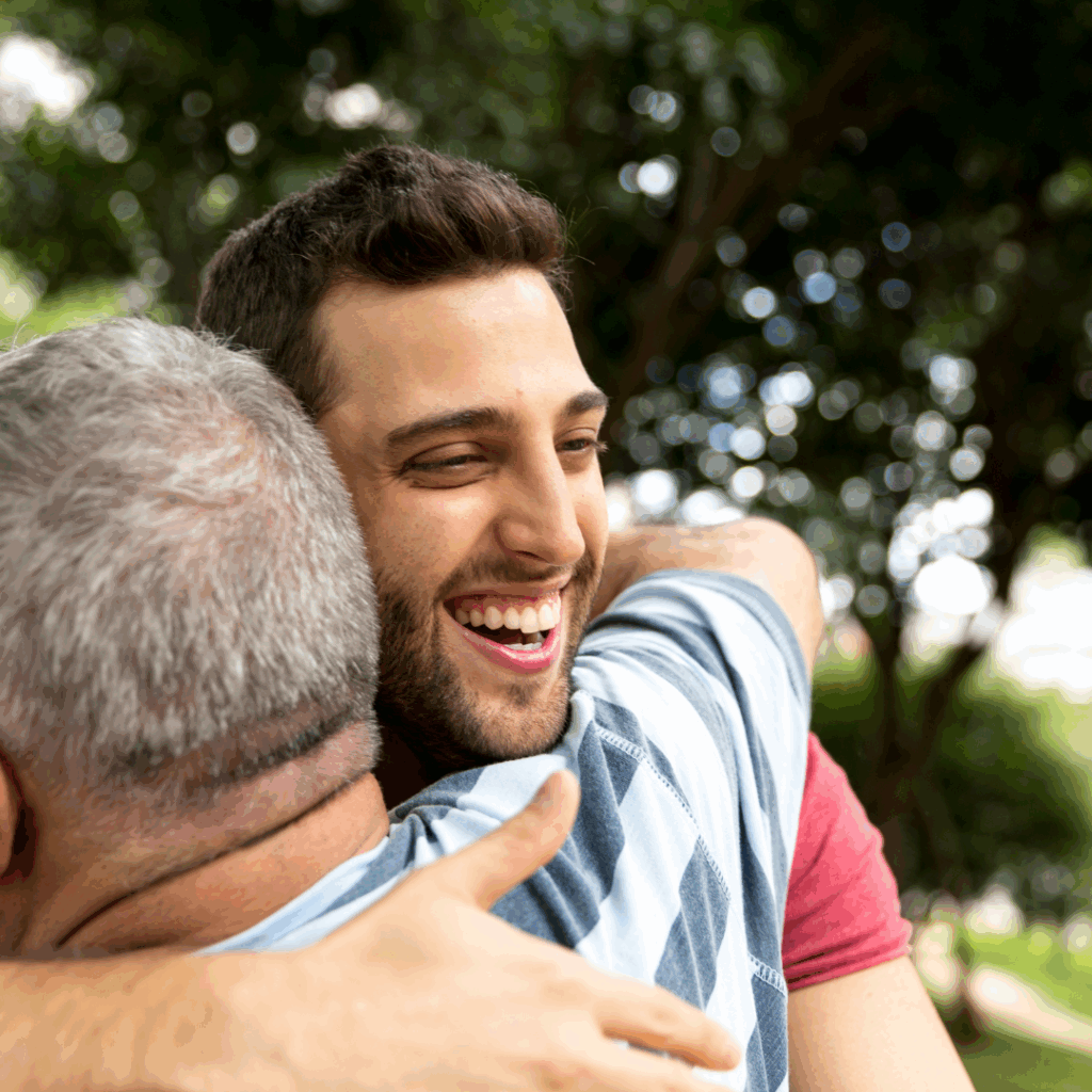 Two men hugging.