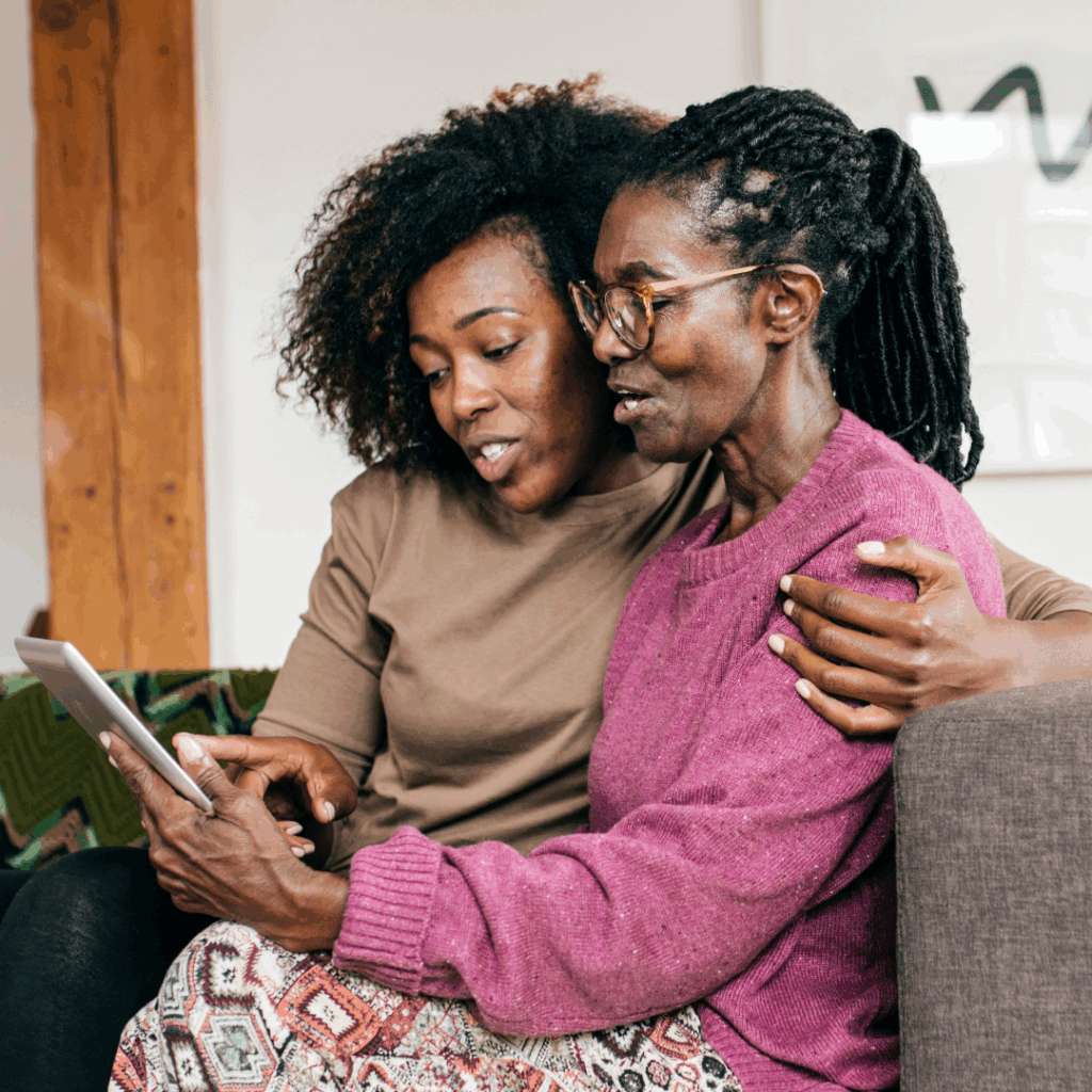 Two women sitting on couch.