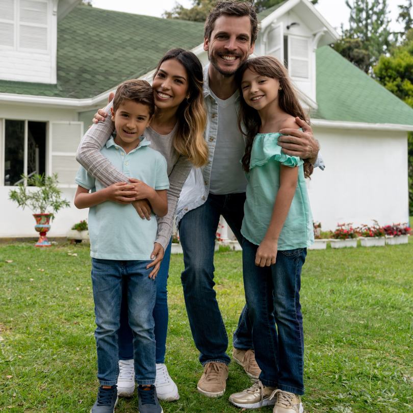Family standing in front of house.
