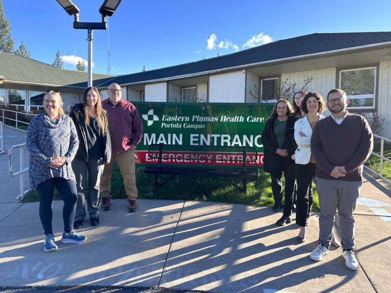 Employee group photo at the Eastern Plumas Health Care Portola Campus during a site visit