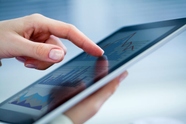 Close-up of female hands touching digital tablet with business diagram